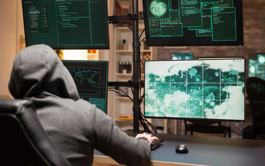 Cyber criminal wearing a hoodie writing a dangerous virus