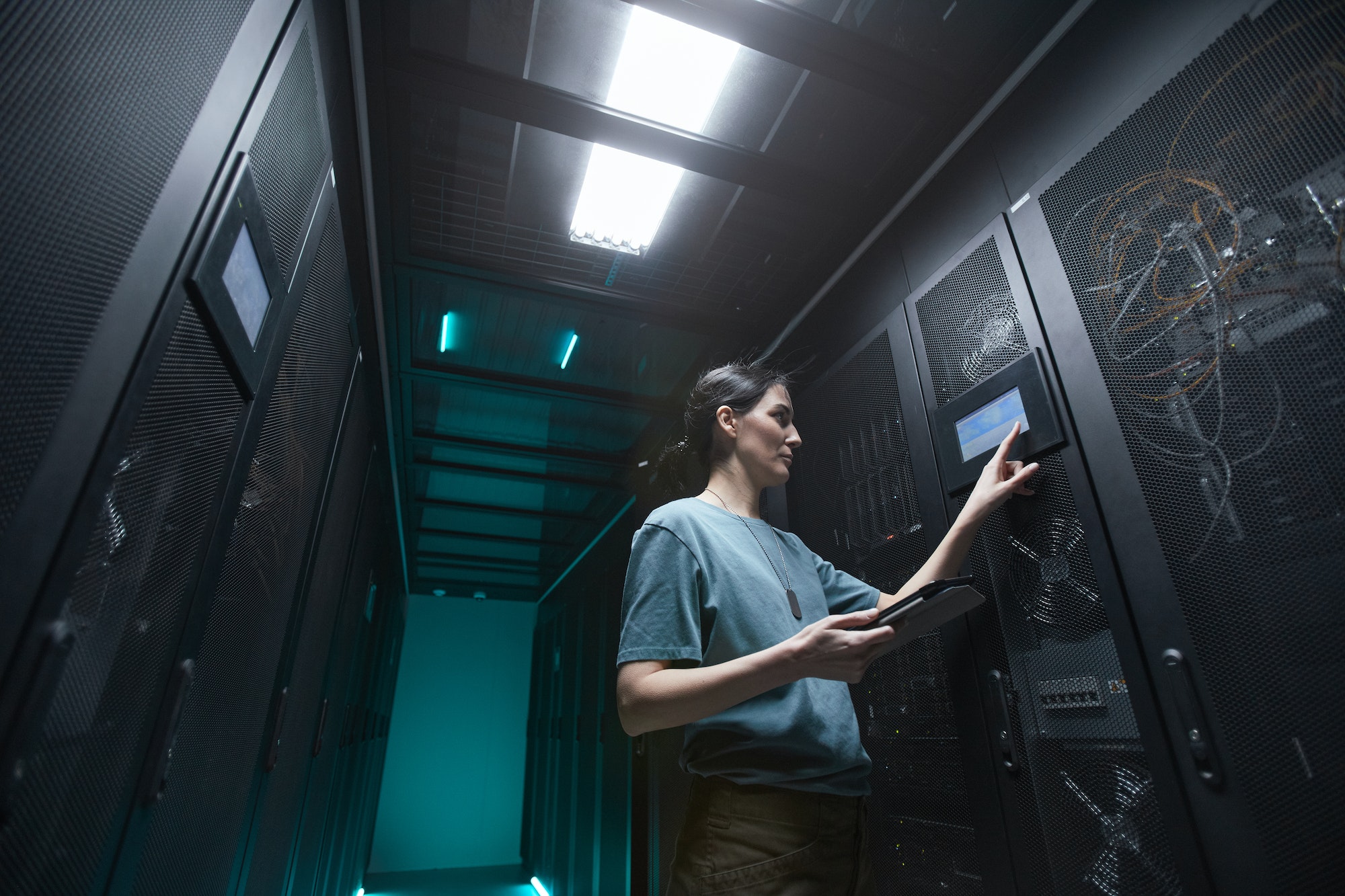 Female IT Technician Managing Server in Data Center