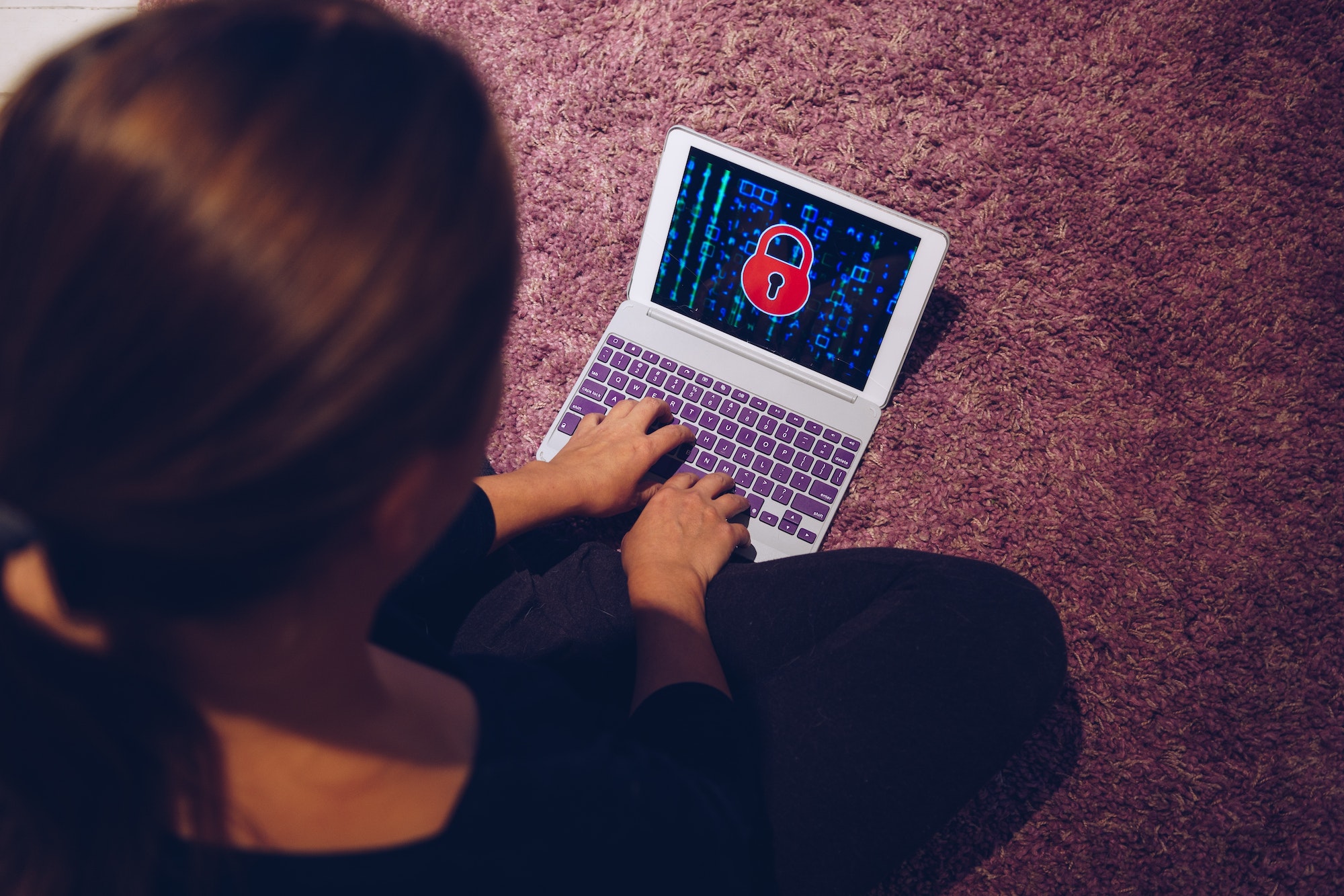 Female woman typing on locked smart device pad attacked by ransomware virus